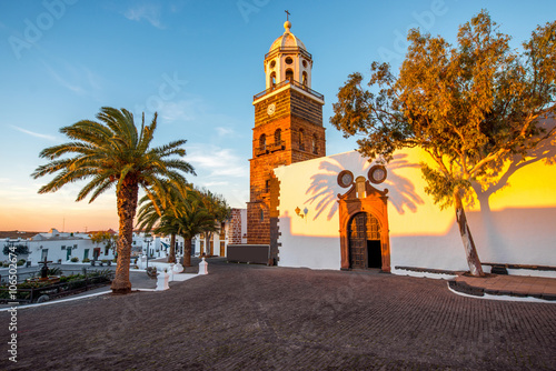 Central square with old church Nuestra Senora de Guadalupe in Teguise village on the sunset on lanzarote island