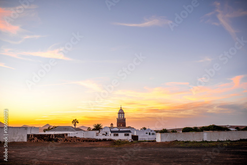 Wide angle view on Teguise village with church tower on the sunset on lanzarote island