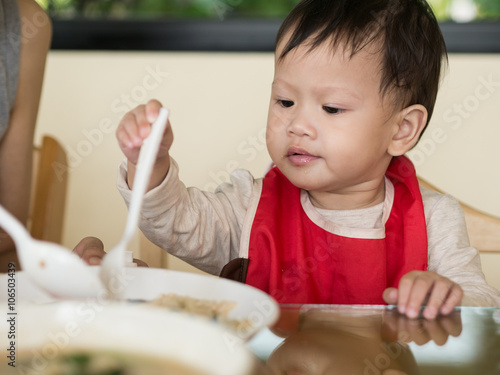 Wallpaper Mural Asian toddler learn to eat meal herself. Torontodigital.ca