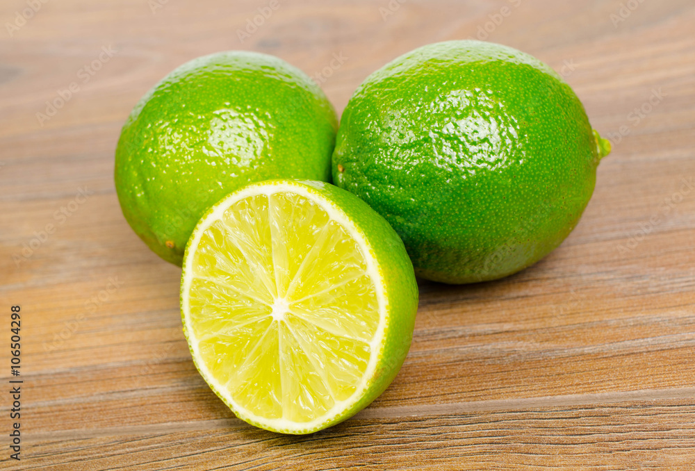 fresh lime wedge on a wood background fresh lime wedge on a wood background