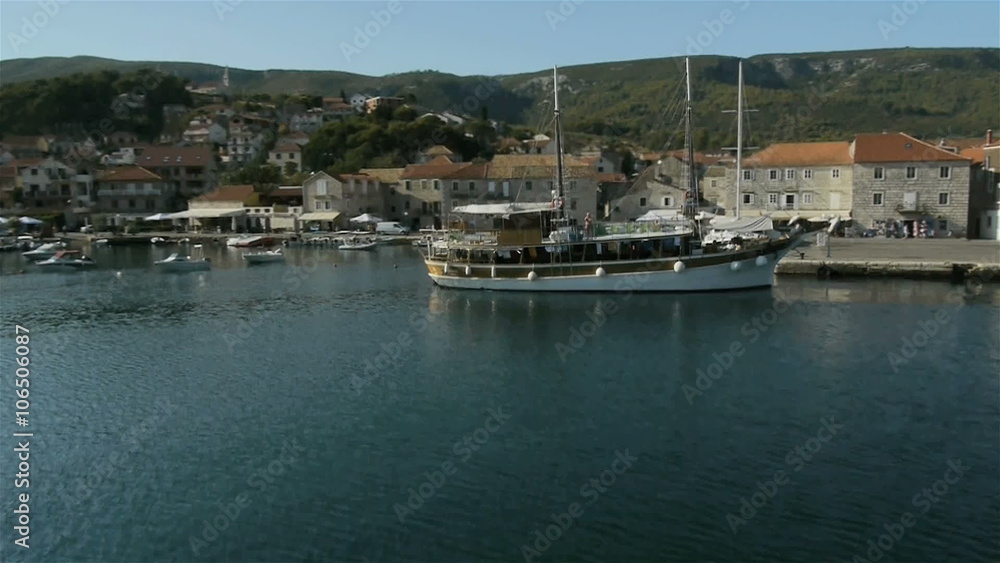 Aerial perspective, how wooden sailing boat start turning and leaving Jelsa marine in the morning of Island Hvar.
Aerial perspective, how wooden sailing boat start turning and leaving Jelsa marine in the morning of Island Hvar.