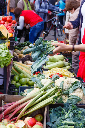 The woman chooses a sprouts in a market