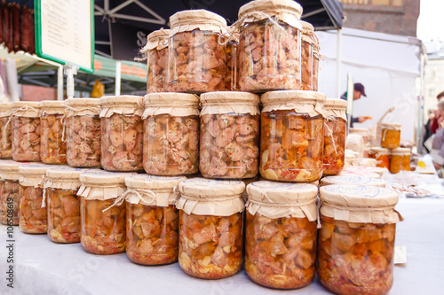Canned homemade meat in a glass jar on market