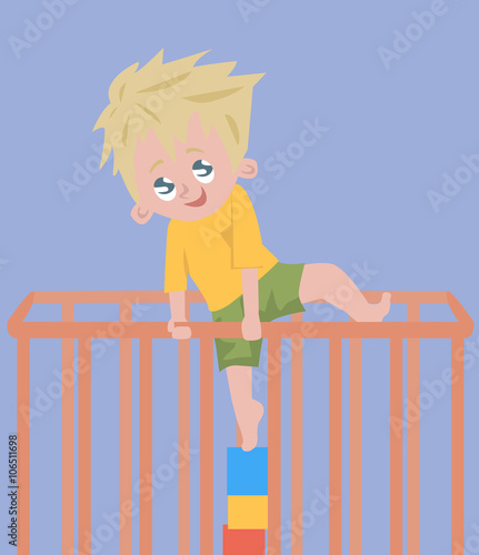 baby boy trying to climb out of playpen