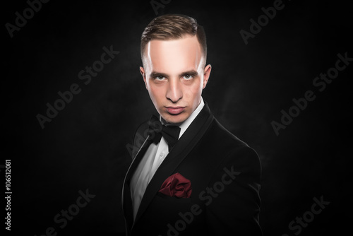 Young handsome man in black suit.