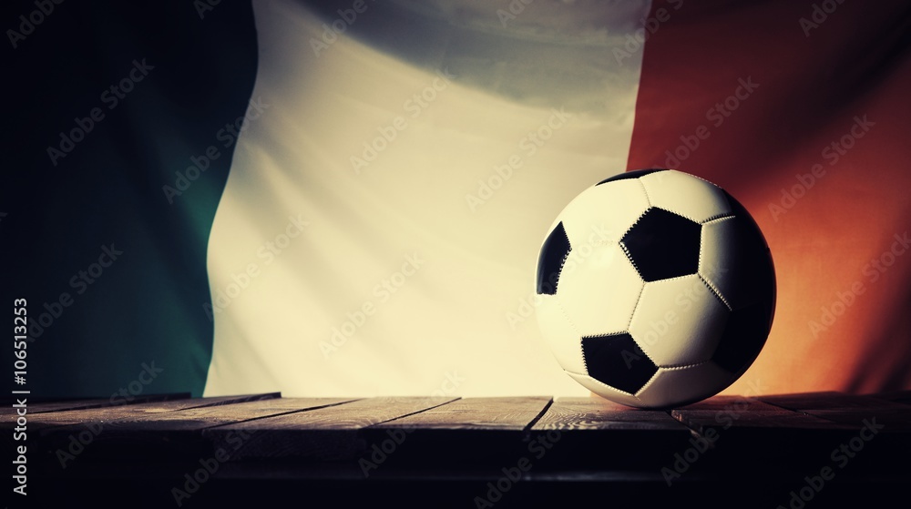 Flag of Ireland with football on wooden boards as the background. Vintage style.