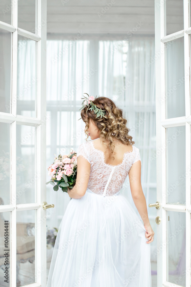 the bride stands with a bouquet the bride stands with a bouquet