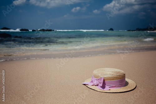 Straw hat on a tropical beach