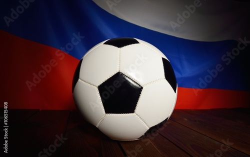 Flag of Russia with football on wooden boards as the background.