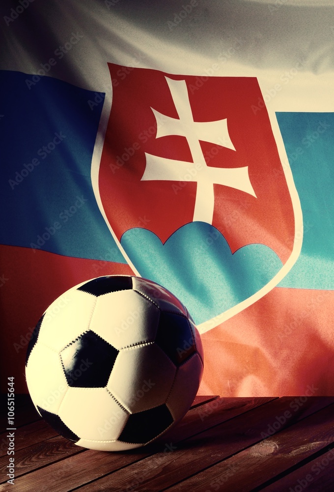 Flag of Slovakia with football on wooden boards as the background. Vintage Style.