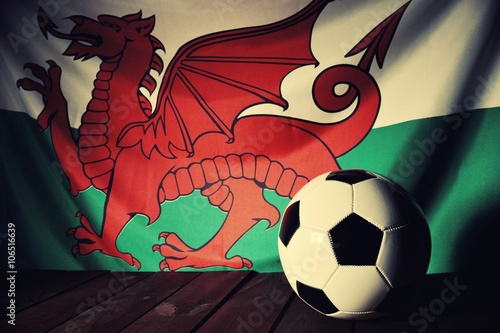Obraz na płótnie Flag of Wales with football on wooden boards as the background. Vintage style. w salonie