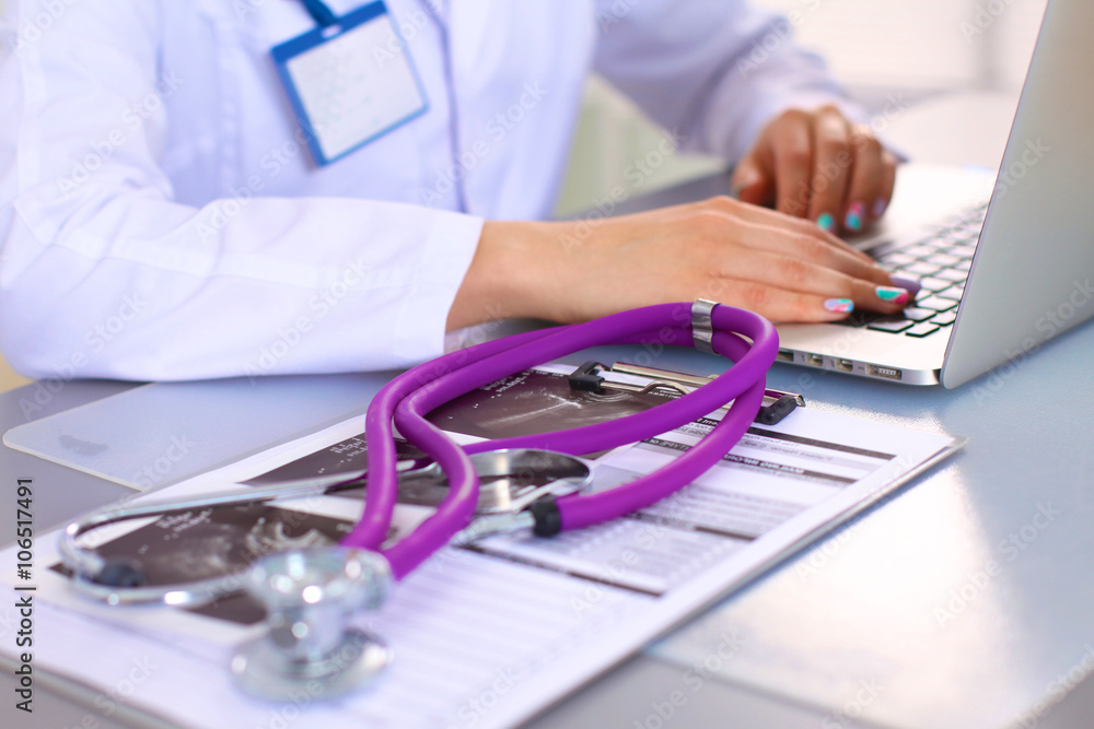Young doctor at the table is receiving patient Young doctor at the table is receiving patient