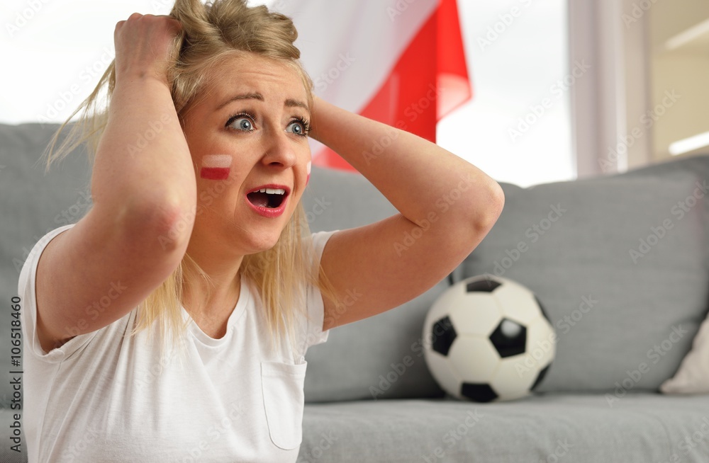Polish fan cheers football team in the national colors.