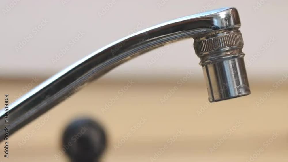 racks focus to dripping closeup of old kitchen faucet. Calcium and mineral deposits encrusted around the spout racks focus to dripping closeup of old kitchen faucet. Calcium and mineral deposits encrusted around the spout