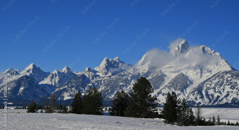 Snow mist blowing off Grand Teton peaks  in Wyoming in the American west of the United States