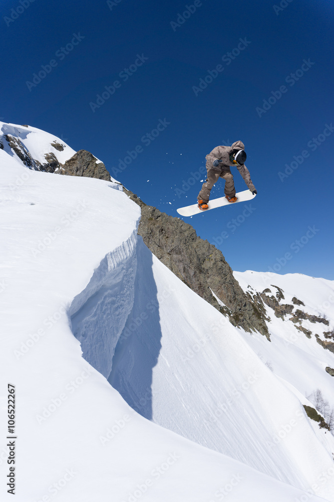 Snowboard jump on mountains. Extreme winter sport.