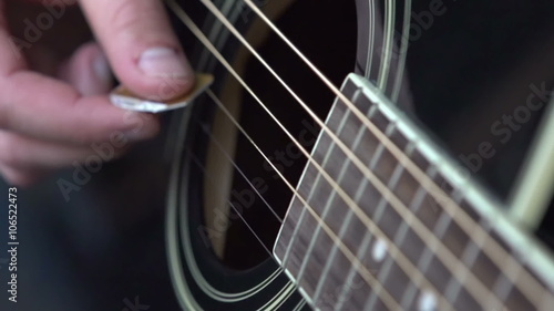 Guitar strings strummed with a pick at 240 fps.