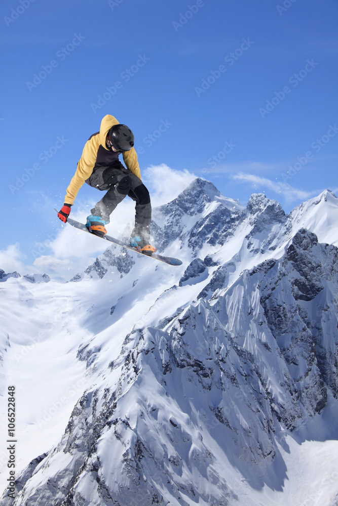 Snowboard jump on mountains. Extreme winter sport.