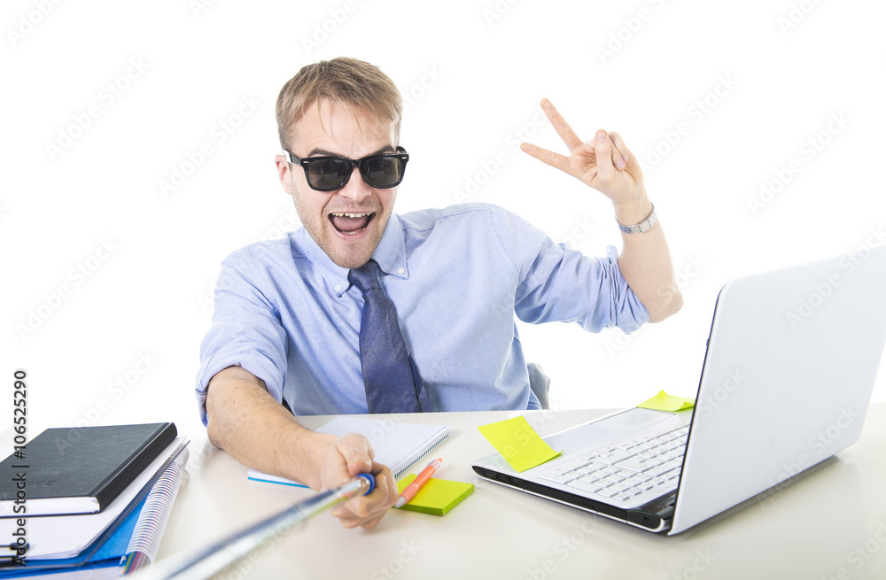 businessman in shirt and tie sitting at office computer desk holding selfie stick shooting self portrait photo businessman in shirt and tie sitting at office computer desk holding selfie stick shooting self portrait photo