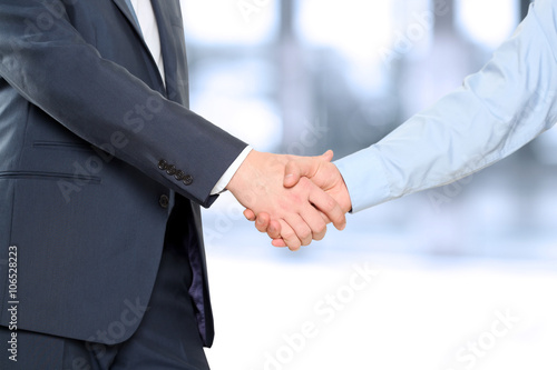 Close-up image of a firm handshake between two colleagues © Saklakova