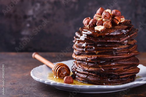 Chocolate pancake with honey and hazelnuts.selective focus