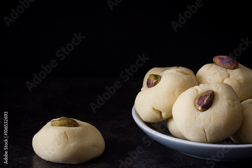 Ghorayeba Egyptian Butter Cookies on a Plate with Pistachios Horizontal with Copy Space photo