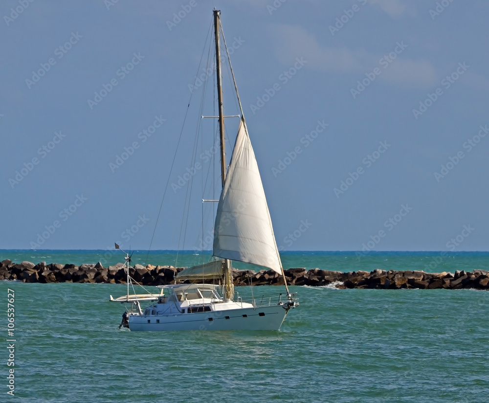 Sailing yacht near miami beach heading east towards the port of miami.
