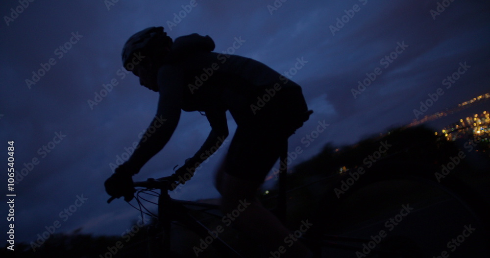 Medium shot of cyclist silhouette on mountain road Medium shot of cyclist silhouette on mountain road