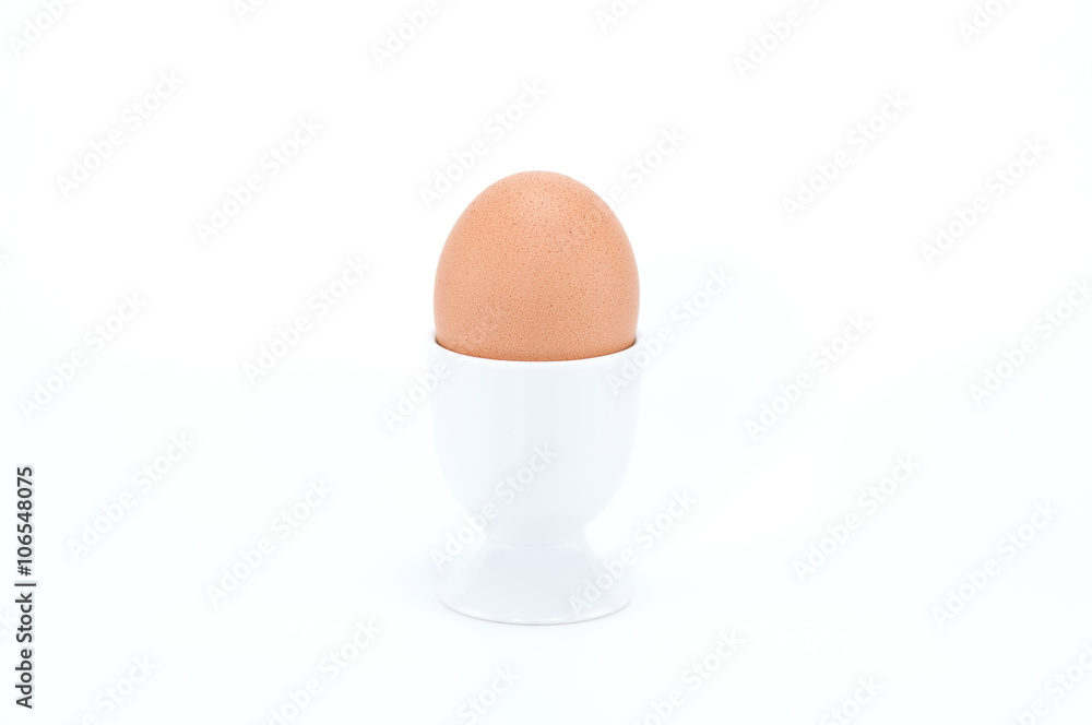 Boiled egg in egg cup on white background. Boiled egg in egg cup on white background.