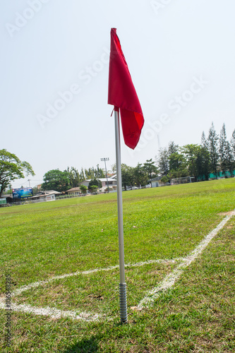 red corner flag and soccer field