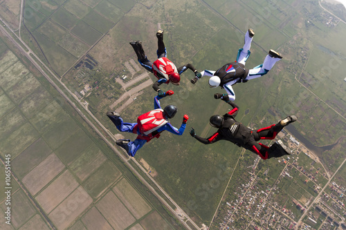 Sports parachutist build a figure in free fall.