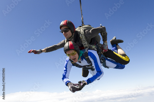 Tandem jump. The instructor and the student in freefall.