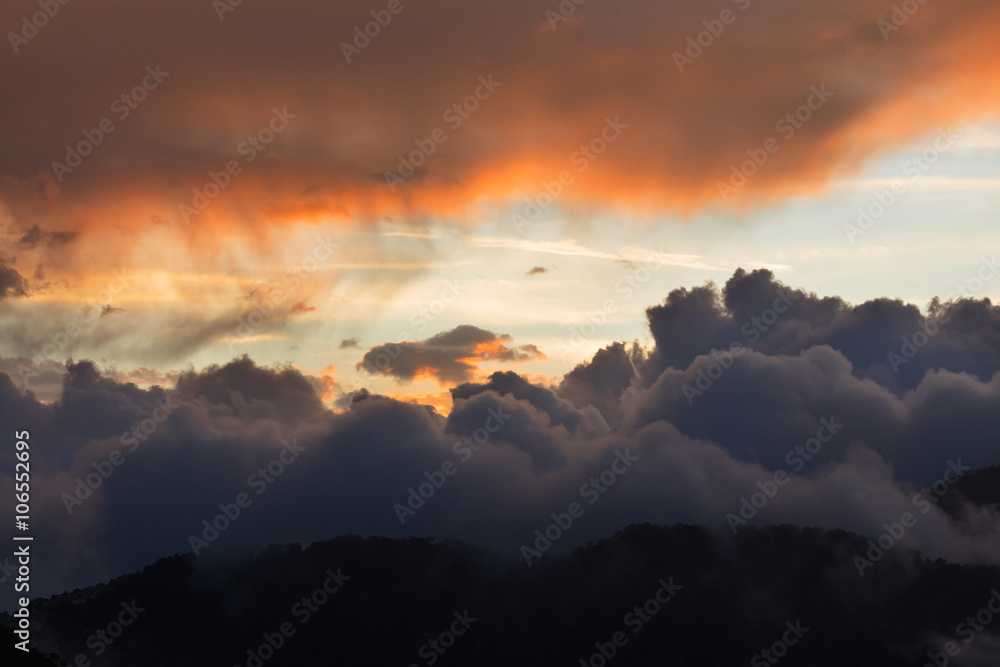 Dramatic cloudscape clouds sunset over mountains