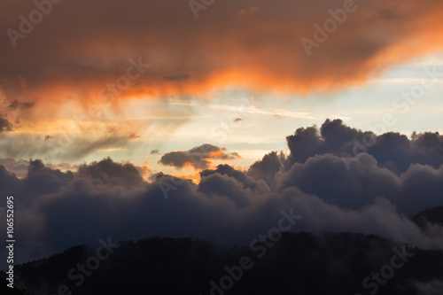 Dramatic cloudscape clouds sunset over mountains