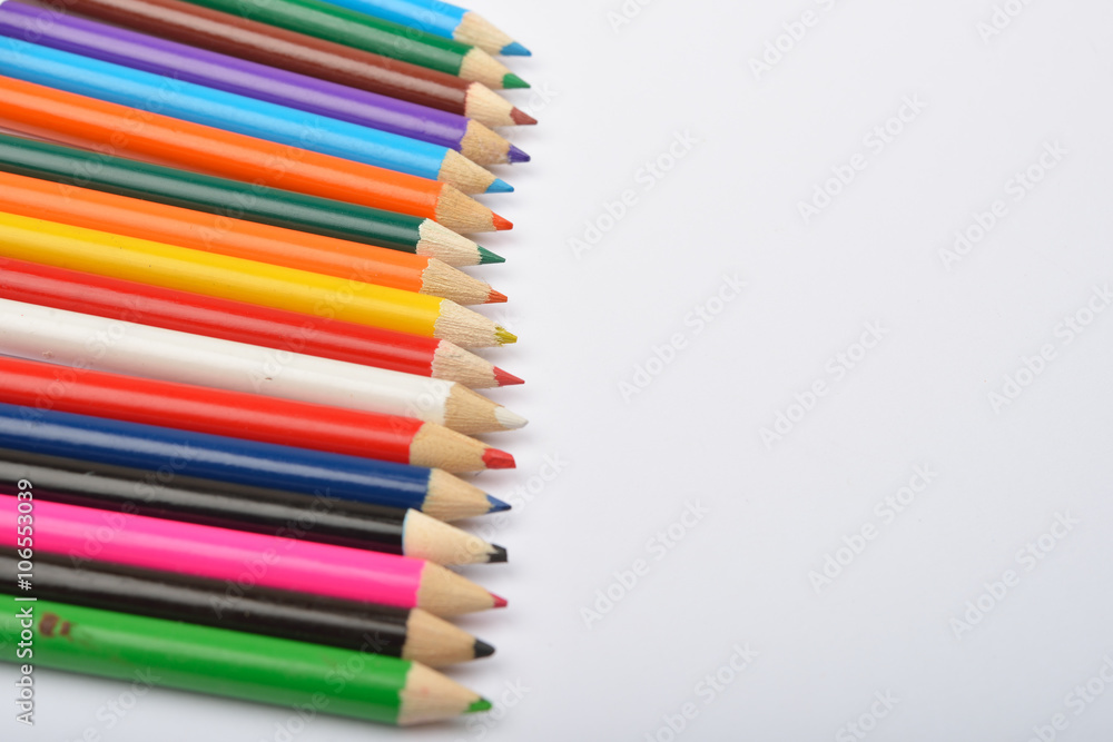 Close up picture of many little colored pencil crayons on white Close up picture of many little colored pencil crayons on white
