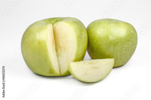 Whole green apple and half with leaf isolated on white backgroun