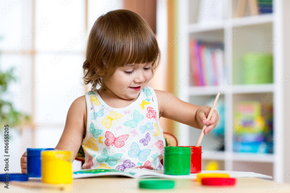 Child painting in kindergarten or playschool Child painting in kindergarten or playschool
