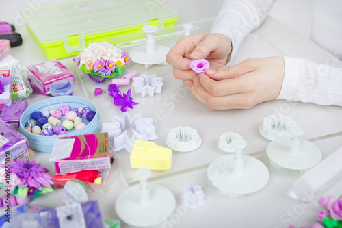 Artist makes jewelry from polymer clay  process. Workshop