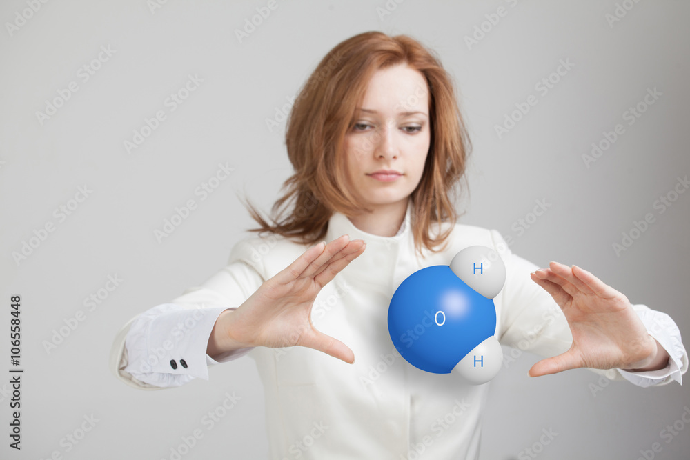 Young woman scientist with model of water molecule. Young woman scientist with model of water molecule.