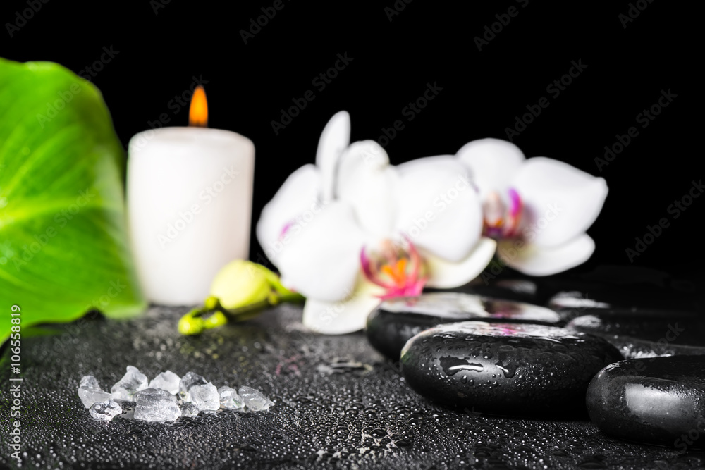 beautiful spa setting of sea salt, black zen stones, white orchi