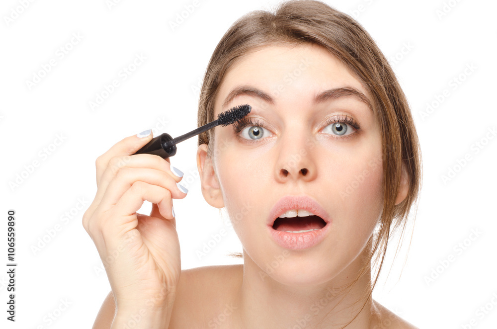 Beautiful woman applying mascara on her eyelashes - isolated on white Beautiful woman applying mascara on her eyelashes - isolated on white
