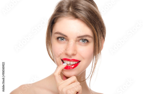 Beauty model girl with perfect face looking at camera smiling with finger in mouth isolated over white