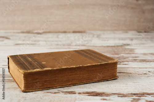 Closed old book. Wood Background