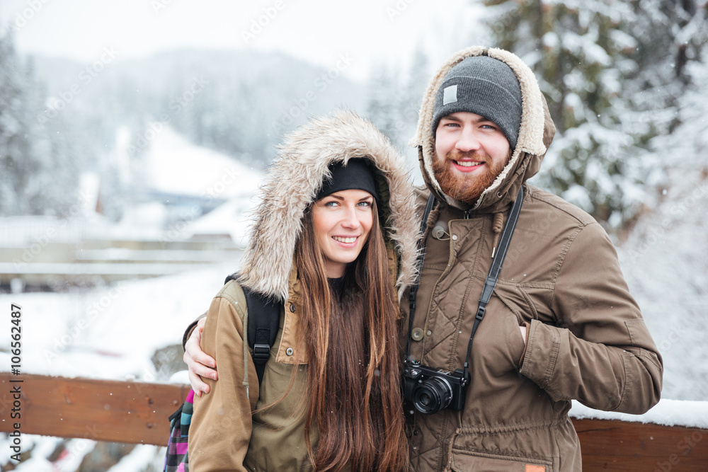 Couple with photo camera on winter mountain resort Couple with photo camera on winter mountain resort