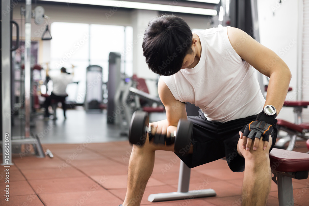 young handsome asian man works out in modern gym young handsome asian man works out in modern gym