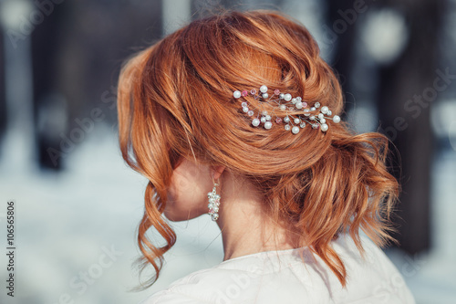 Fototapeta Back view of unrecognizable young woman with red hair in white