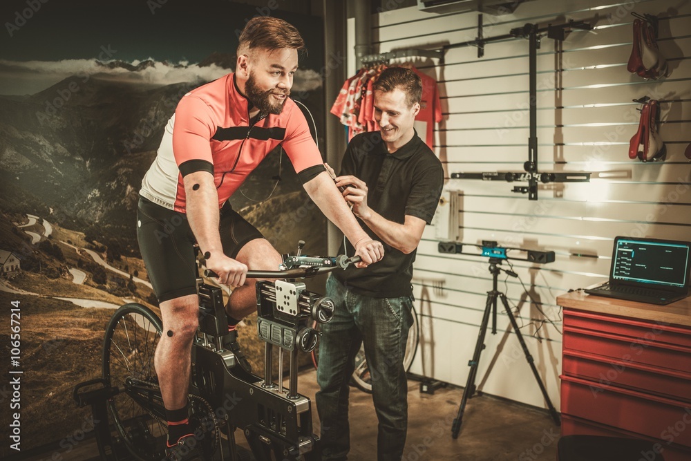 Fototapeta premium Professional cyclist being tested on body geometry simulator in fit services.