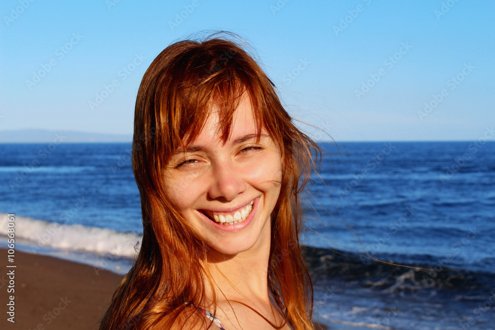 Smiling girl's face portrait, close-up woman's face with the smile with the blue sea on the background, Philippines Smiling girl's face portrait, close-up woman's face with the smile with the blue sea on the background, Philippines