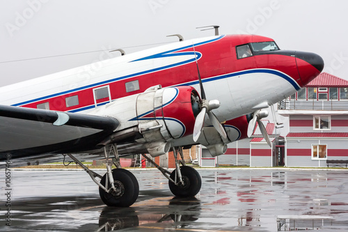 Retro plane on the rainy day at the airport