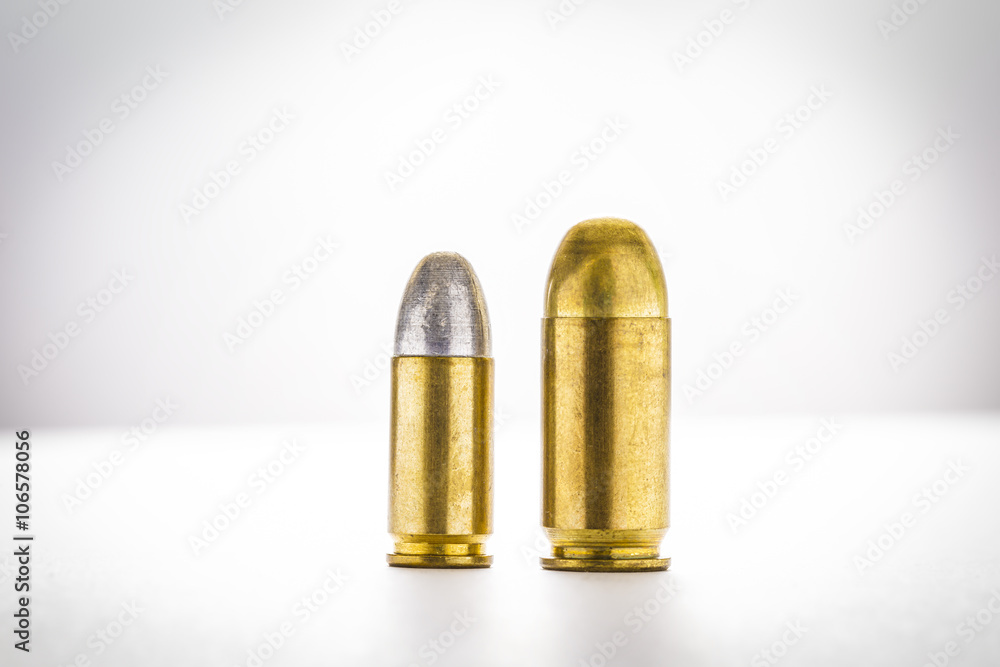 cartridges of 11mm and 9mm pistols ammo, Size does matter concept cartridges of 11mm and 9mm pistols ammo, Size does matter concept